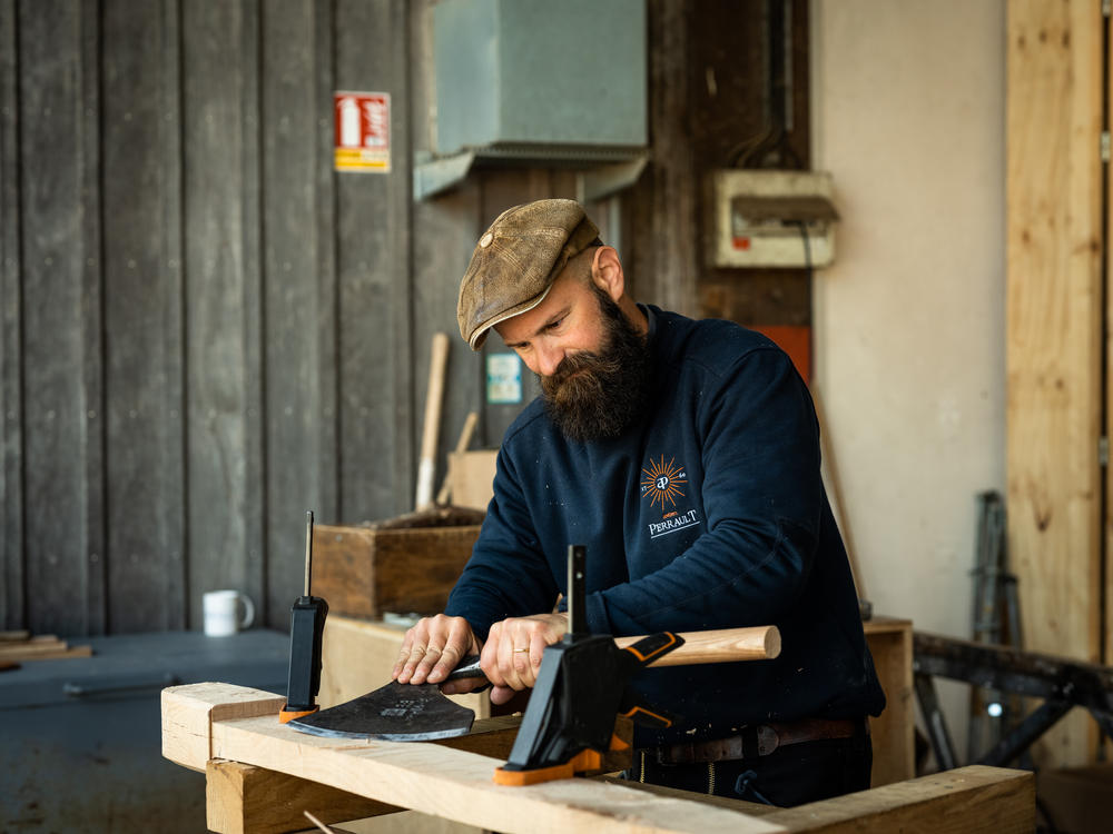 Edouard Cortes, one of Ateliers Perrault's carpenters, stands at his workstation. 