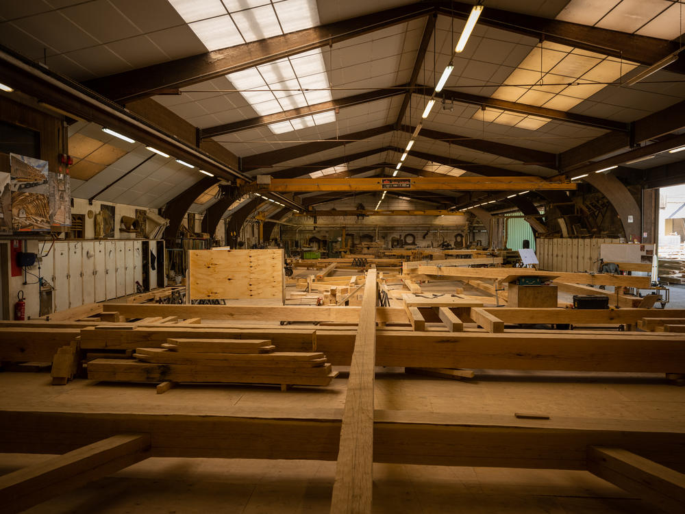 Notre Dame's newly built trusses inside the Ateliers Perrault in Saint-Laurent-de-la-Plaine, France.