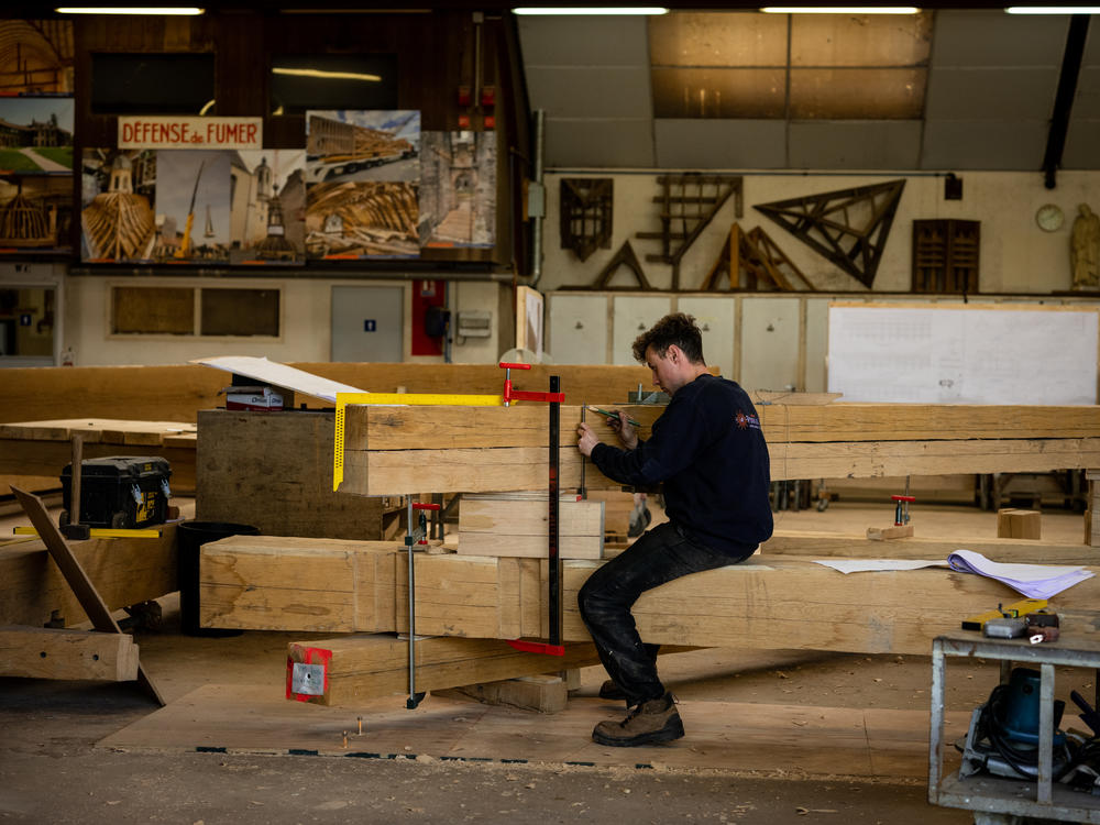 Valentin Pontarollo, 29, one of the lead carpenters on Notre Dame's reconstruction, works on the beams that will constitute the cathedral's new framework.