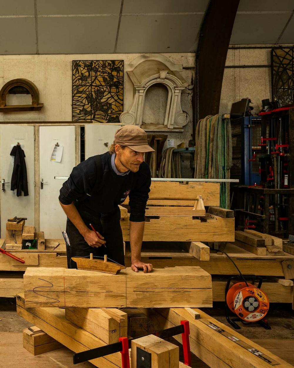 Carpenters work on trusses for the Notre Dame Cathedral.