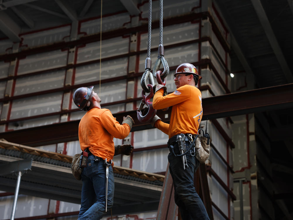 Construction workers prepare steel for a crane at the site of JPMorgan Chase's new headquarters in New York City on May 18, 2023. Builders added jobs this month despite the headwinds from higher interest rates. It was another indication of the country's strong job market.