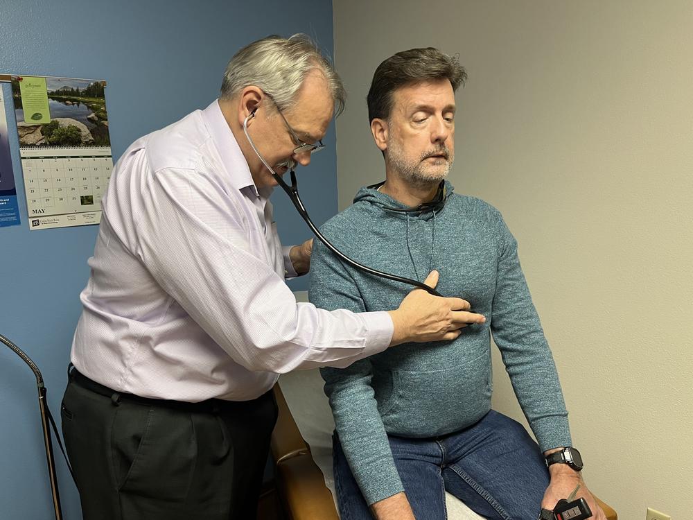 Osteopathic physician Kevin de Regnier of Winterset, Iowa, checks Chris Bourne, who came in for an adjustment of his anxiety medication on May 9, 2023.