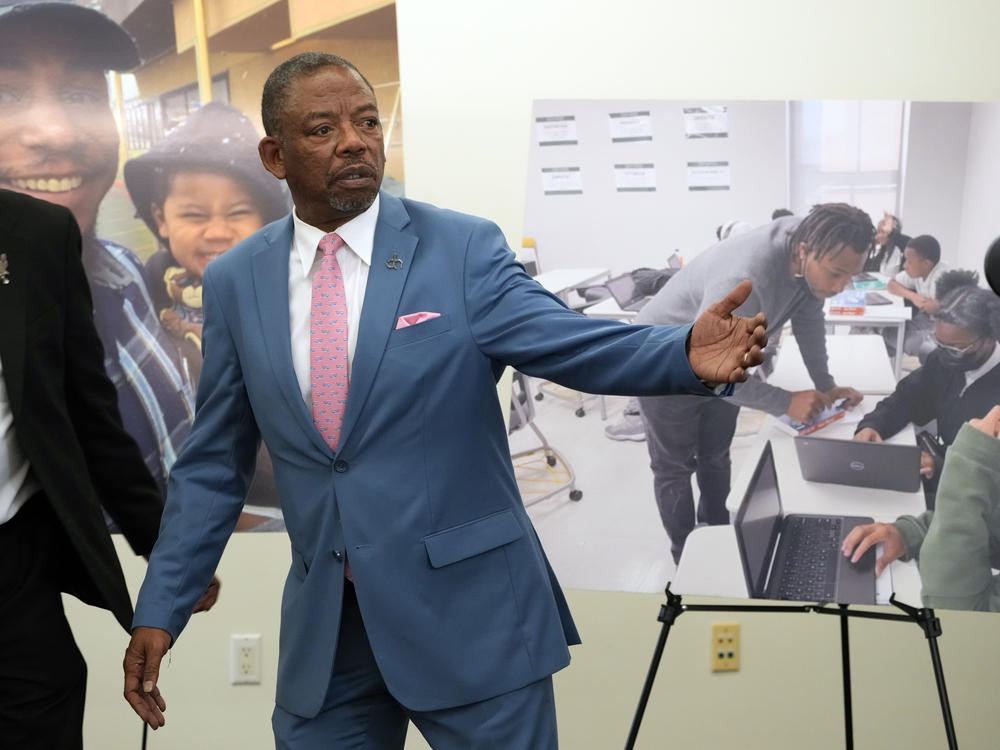 Lawyers Benjamin Crump, left, and Carl Douglas, right, held a news conference in January to announce their filing of a $50 million claim against the city of Los Angeles over the death of Keenan Anderson, who is pictured on posters.
