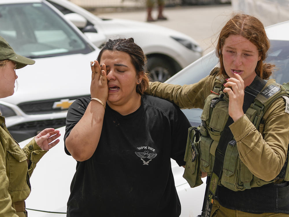An Israeli soldier cries outside a military base following a deadly shootout in southern Israel along the Egyptian border on Saturday.