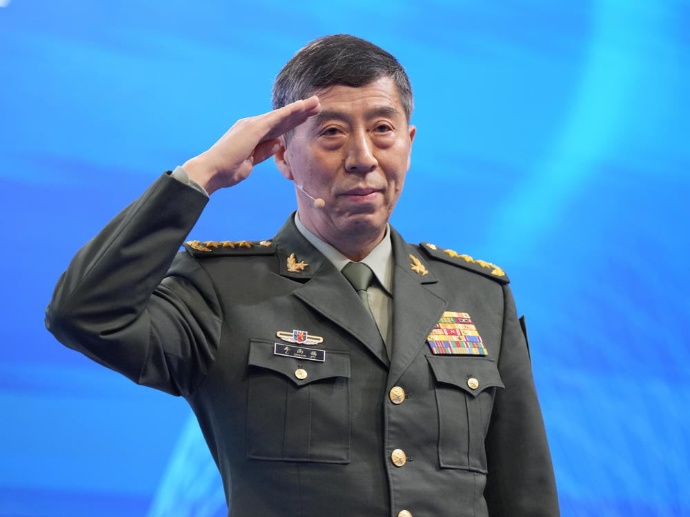 Chinese Defense Minister Li Shangfu salutes before delivering his speech on the last day of the 20th International Institute for Strategic Studies (IISS) Shangri-La Dialogue, Asia's annual defense and security forum, in Singapore, Sunday, June 4, 2023.