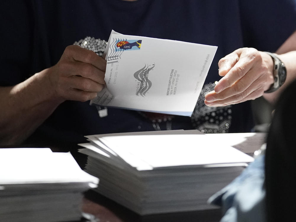 An election worker continues the process of counting ballots for the 2022 Pennsylvania primary election in Mercer, Pa.