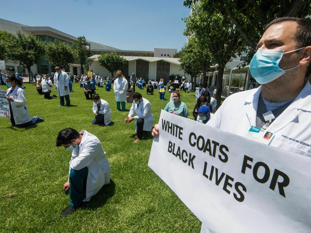 It's still early days for AI in health care, but already racial bias has been found in some of the tools. Here, health care professionals at a hospital in California protest racial injustice after the murder of George Floyd.