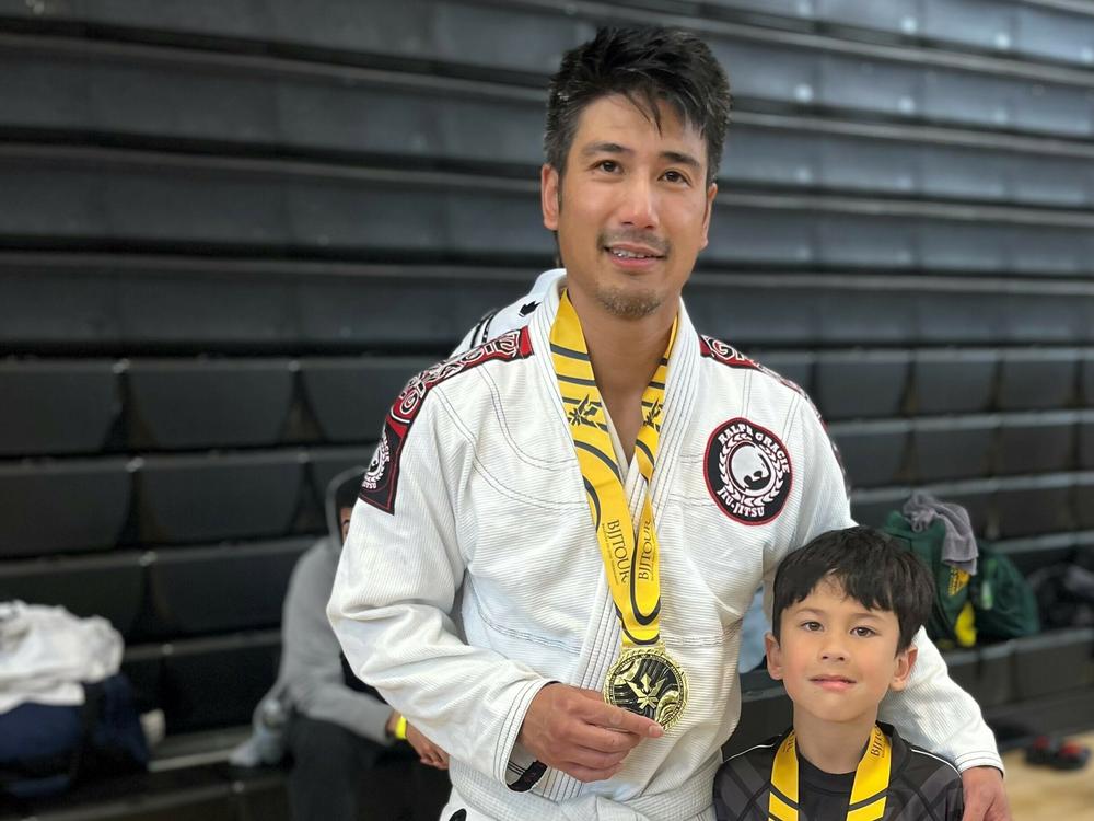 Ibrahim and his son Jameson after they both won gold medals.