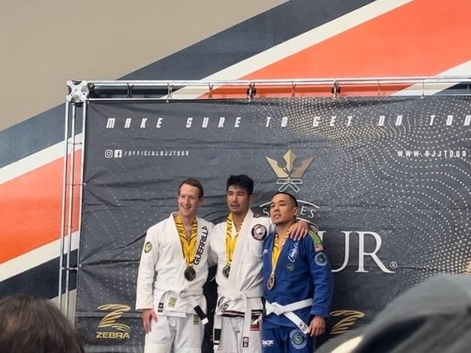Mark Zuckerberg, left, alongside Jeff Ibrahim, center, following their jiu-jitsu match on May 6 in California. One of the third place competitors, Henry Francisco, is at right.