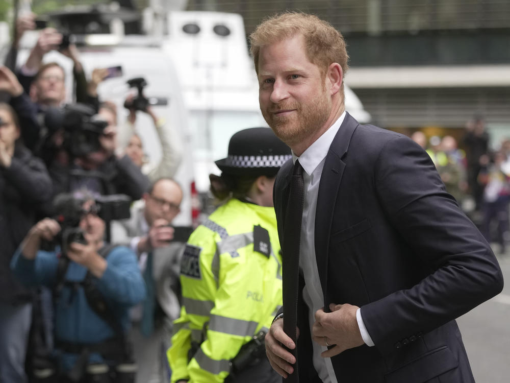 Prince Harry arrives at the High Court in London on Tuesday to testify against a tabloid publisher he accuses of phone hacking and other unlawful snooping.