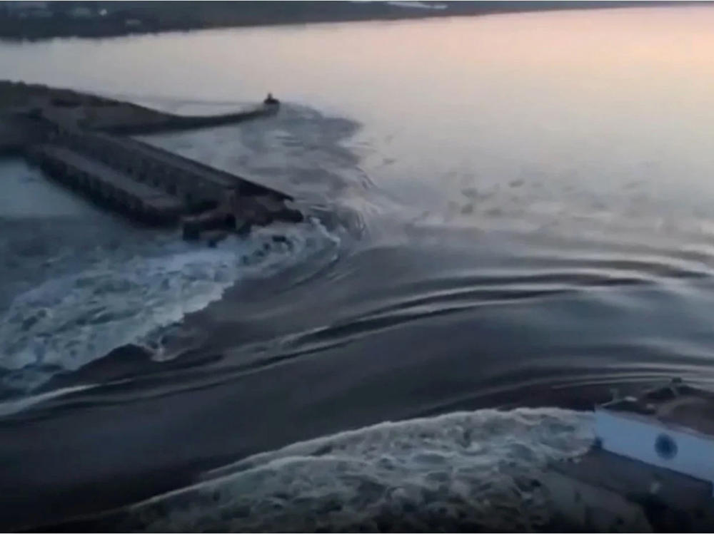 In a photo taken from video released by the Ukrainian Presidential Office, water surges through a break in the Kakhovka dam in southern Ukraine. Ukraine and Russia are both accusing each other of blowing up the dam, which also destroyed an attached hydroelectric power station.
