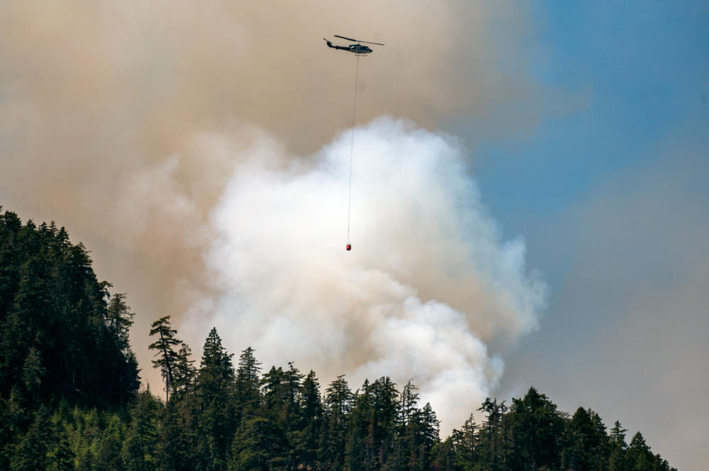 A helicopter waterbomber flies above the Cameron Bluffs wildfire near Port Alberni, British Columbia, Canada, on Monday, June 5, 2023. Canada is on track to see its worst-ever wildfire season in recorded history if the rate of land burned continues at the same pace.