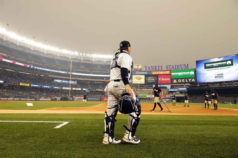 Jose Trevino of the New York Yankees walks out onto the field during a hazy game against the Chicago White Sox at Yankee Stadium on Tuesday.<a></a>