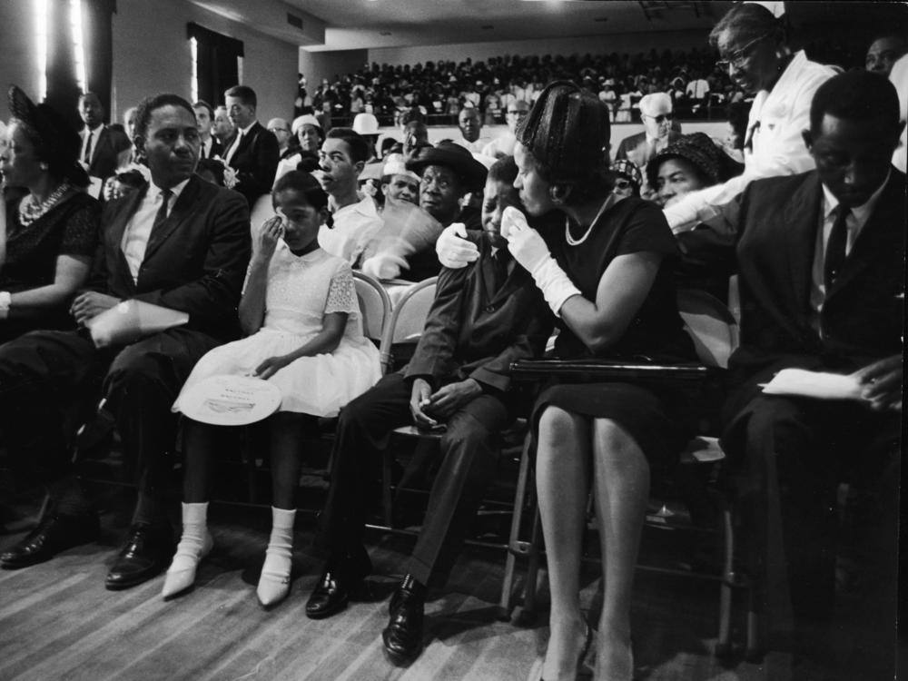 At the funeral for Medgar Evers, his wife, Myrlie Evers (second right), comforts their son, Darryl Kenyatta Evers, while daughter Reena Denise Evers (center, in white dress) wipes her own tears in Jackson, Miss., on June 18, 1963.
