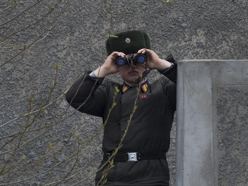 A North Korean soldier looks across the Yalu river near Sinuiju, opposite the Chinese border city of Dandong in April 2017.