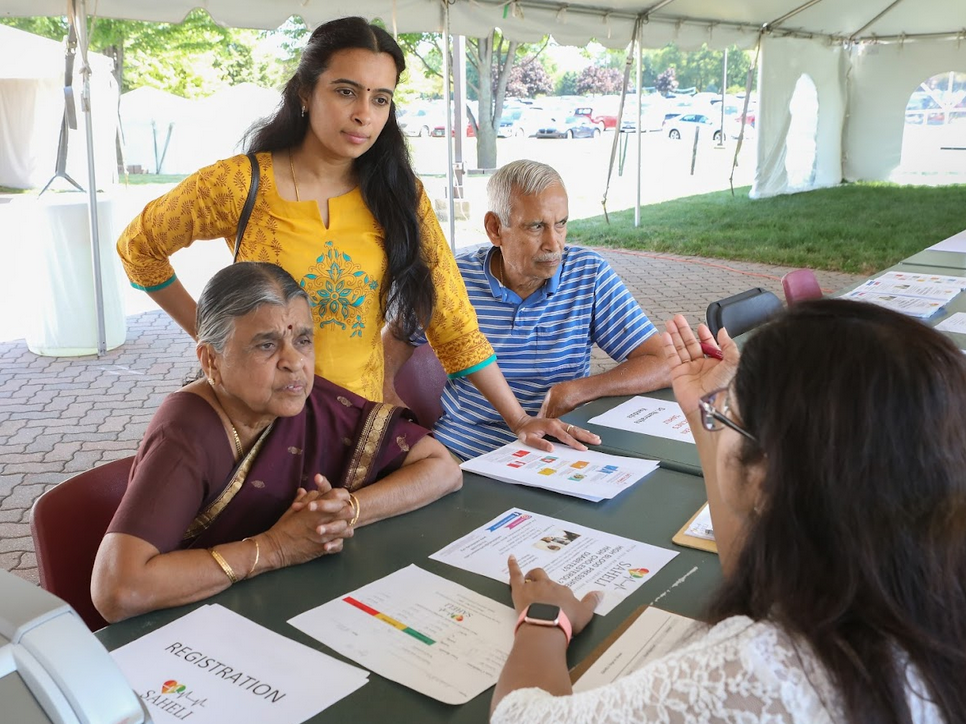 Attendees at a health fair at the  Balaji Temple, in Aurora, Ill., learn about the SAHELI diabetes prevention program.
