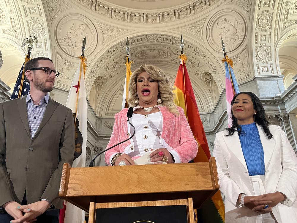D'Arcy Drollinger delivers her inaugural speech as drag laureate flanked by California State Senator Scott Wiener, left, and San Francisco Mayor London Breed.