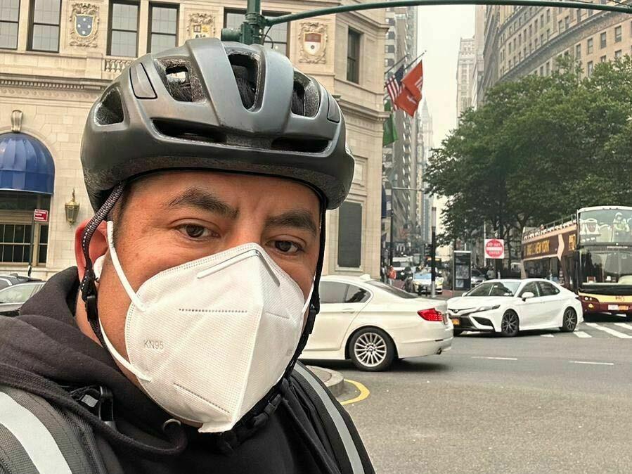 Gustavo Ajche snapped a selfie on the street while making his rounds on Wednesday.