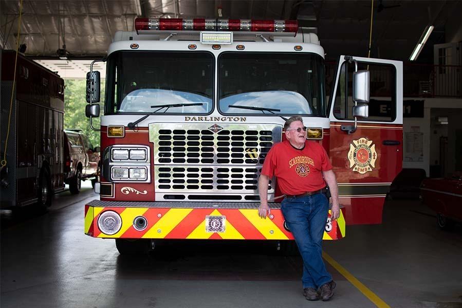 Jerry Scarborough, 69, leans on the bumper of Engine 913 at Darlington Volunteer Fire Company's fire station 2 in Street, Maryland.