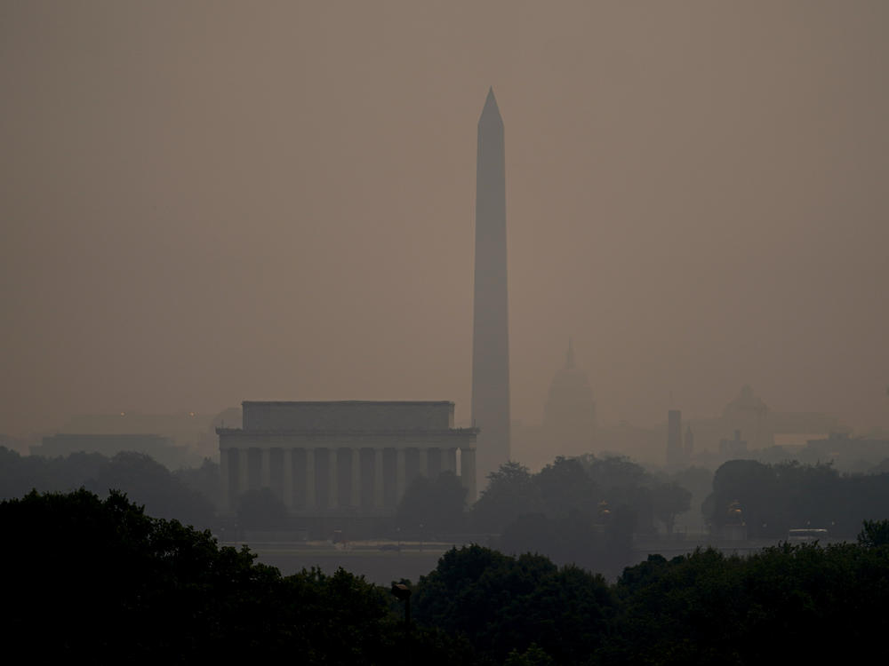 Haze blankets over monuments on the National Mall in Washington, Wednesday, as seen from Arlington, Va.