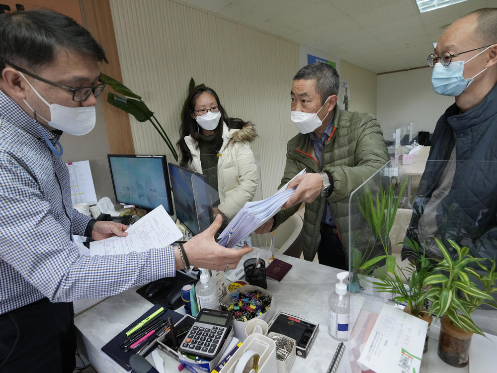 Peter Møller, second from right, attorney and co-founder of the Danish Korean Rights Group, submits the documents at the Truth and Reconciliation Commission in Seoul, South Korea, Nov. 15, 2022.