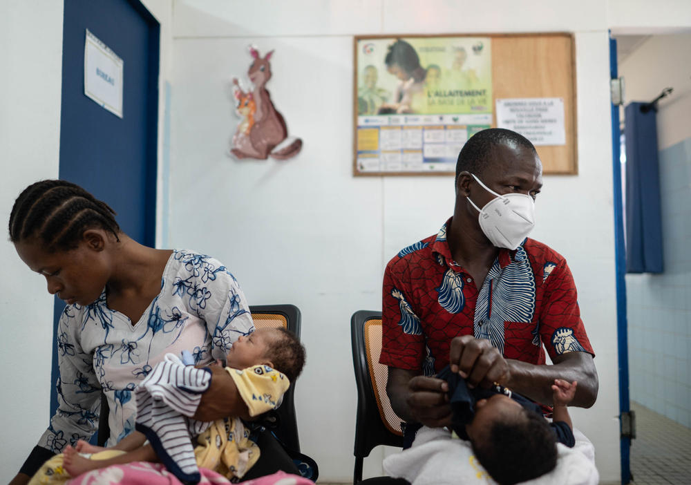 Bru Adjen (right) and his wife, cradle their twins Bru Andu (right) and Kris Emmanual during their weekly checkup. Daughter Kris was part of the hospital's kangaroo care program but was discharged when she passed the 4 pound weight marker.