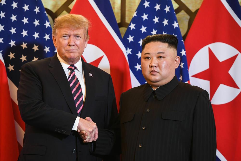 Donald Trump shakes hands with Kim Jong Un before a meeting in Hanoi in February 2019.