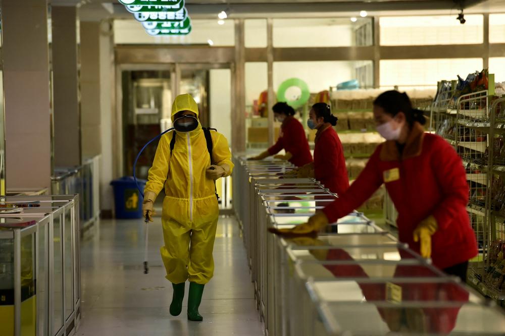 Employees spray disinfectant and wipe surfaces as part of preventative measures against the coronavirus at the Pyongyang Children's Department Store in March 2022.