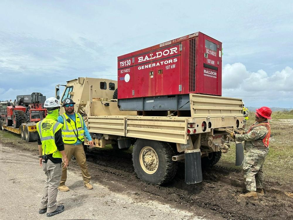At a staging area, workers prepare to send out heavy equipment and generators across Guam to help in the recovery after Typhoon Mawar.