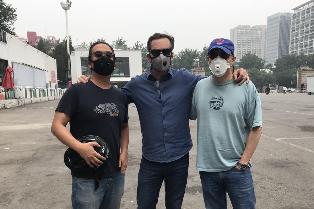 NPR's Anthony Kuhn (right), with Bob Woodruff (middle) and Karson Yiu (left), both of ABC News, at Beijing Workers' Stadium in May 2018.