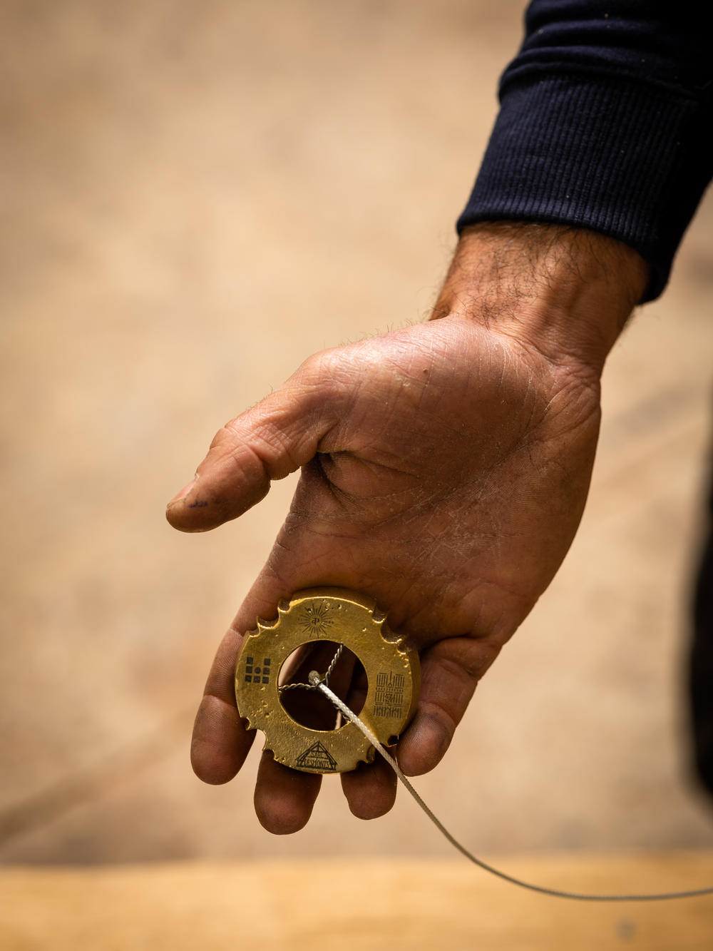 Carpenter Matthieu Gornouvel works on the cathedral's framework using a weight engraved with an image of Notre Dame's facade.