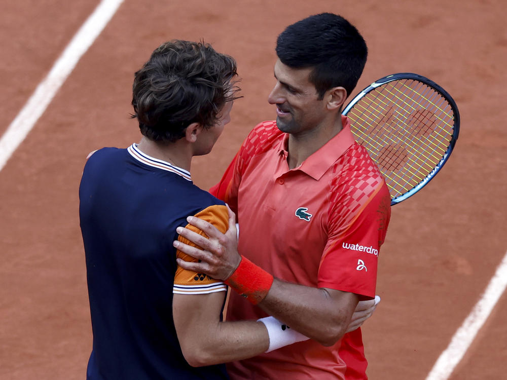 Serbia's Novak Djokovic, right, hugs Norway's Casper Ruud after winning their final match of the French Open tennis tournament at the Roland Garros stadium in Paris on Sunday.