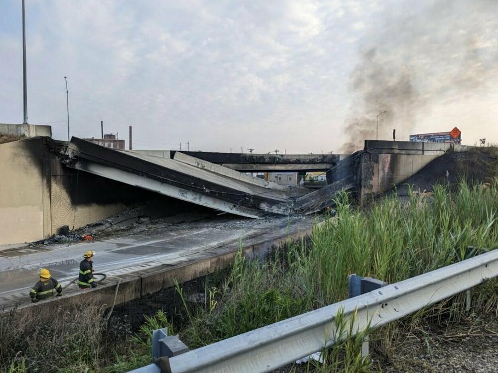 Firefighters work near a section of I-95 in Philadelphia that collapsed Sunday following a vehicle fire.