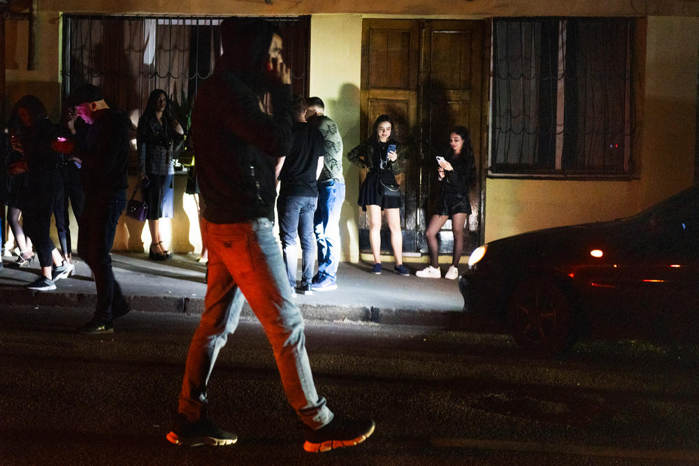 Just after 11 p.m., people leave the club when police arrived, standing outside and waiting to see if the party will continue.