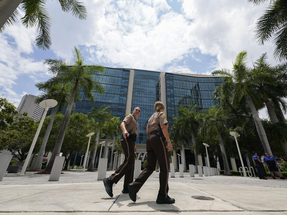 Miami-Dade Sheriff deputies walk in front of the Wilkie D. Ferguson Jr. federal courthouse building in Miami on Friday.