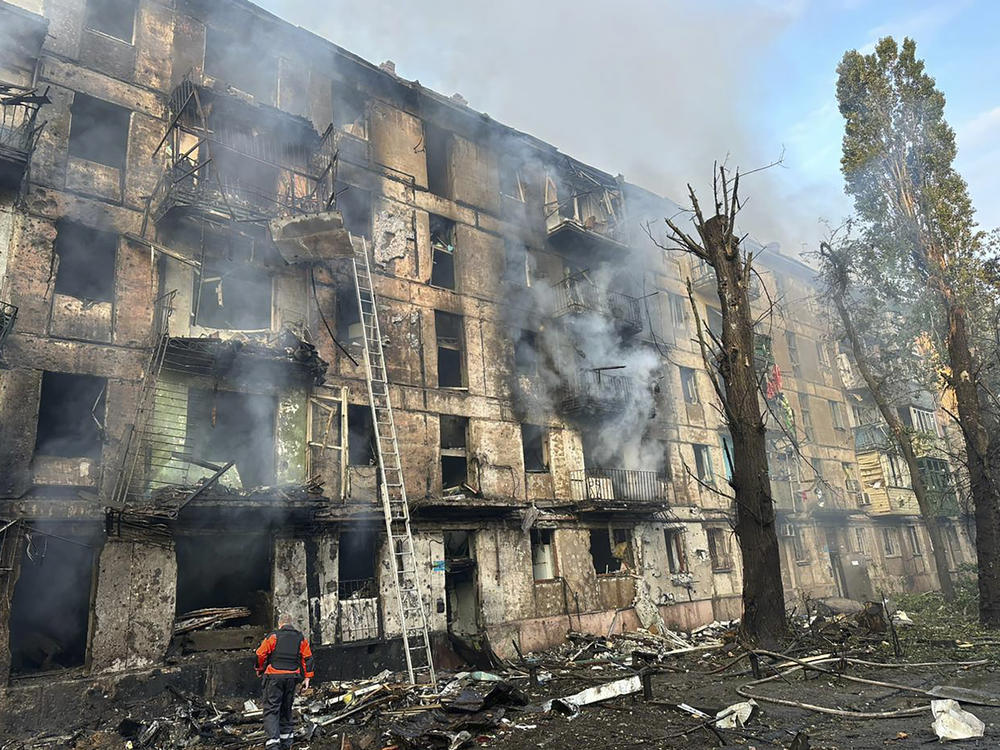 In this photo released by Dnipro Regional Administration, emergency workers extinguish a fire after missiles hit a multi-story apartment building in Kryvyi Rih, Ukraine, Tuesday, June 13, 2023.