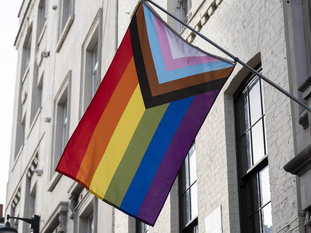 A pride progress flag hangs on a building in November 2022 in London.