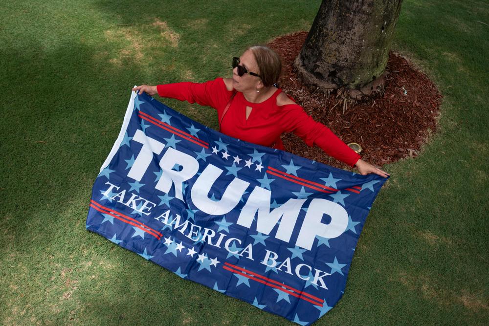A supporter of former President Trump sits outside Trump National Doral resort in Doral, Florida, on June 12, 2023.