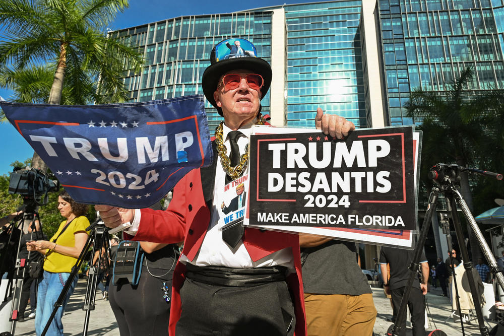 Gregg Donovan shows his support outside the Wilkie D. Ferguson Jr. United States Courthouse before the arraignment of former President Trump.