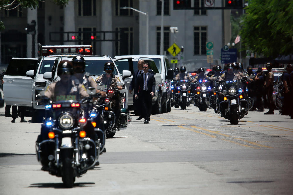 Police motorcycles used to escort the motorcade carrying former President Trump arrive at the Wilkie D. Ferguson Jr. United States Federal Courthouse.