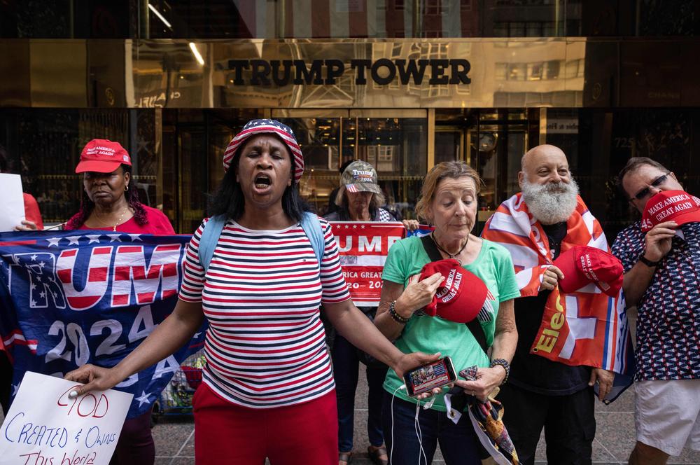 Supporters of former President Trump pray during a demonstration outside of Trump Tower in New York City.