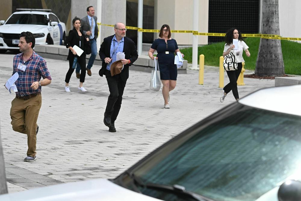 Members of the media run out of Wilkie D. Ferguson Jr. United States Federal Courthouse.
