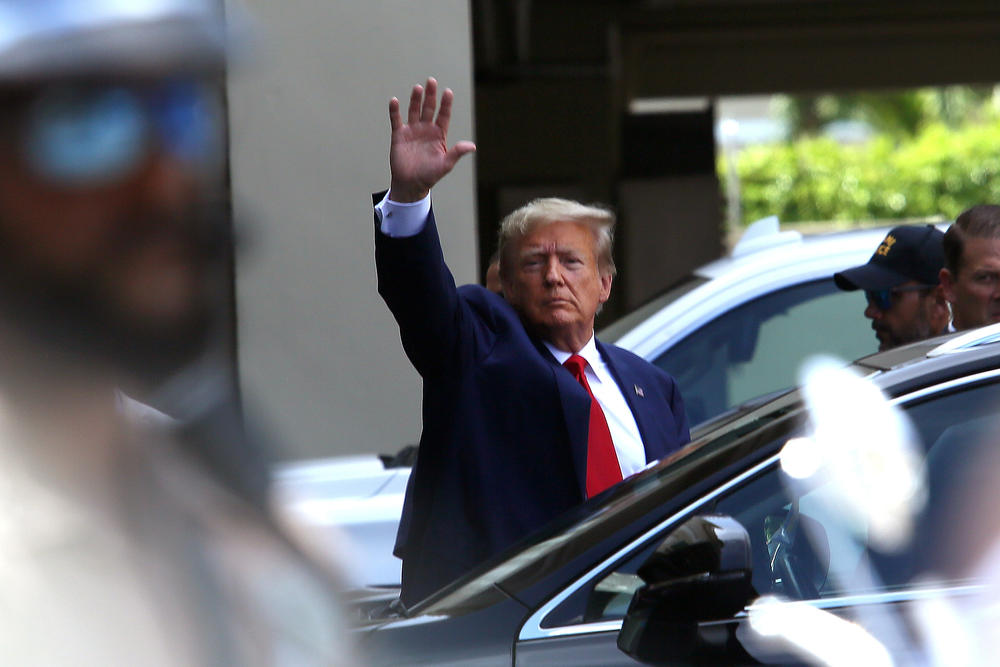 Former President Trump waves as he makes a visit to the Cuban restaurant Versailles after he appeared for his arraignment on June 13, 2023 in Miami, Florida.