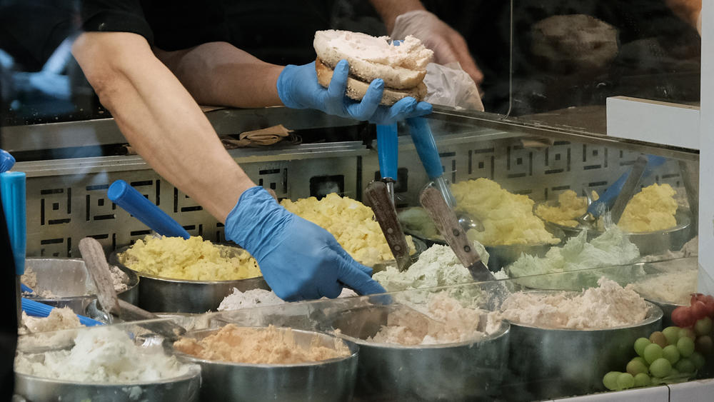 Cream cheese is loaded onto a bagel at Pick a Bagel in Manhattan.