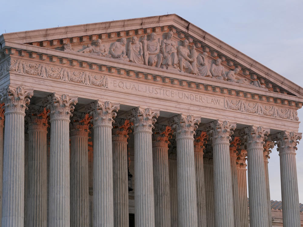 The setting sun illuminates the Supreme Court building on Capitol Hill in Washington on Jan. 10, 2023.