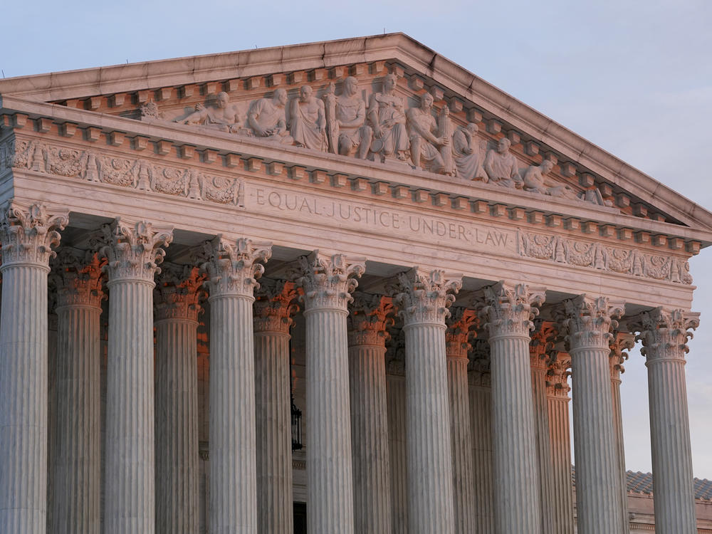 The setting sun illuminates the Supreme Court building in Washington on Jan. 10.