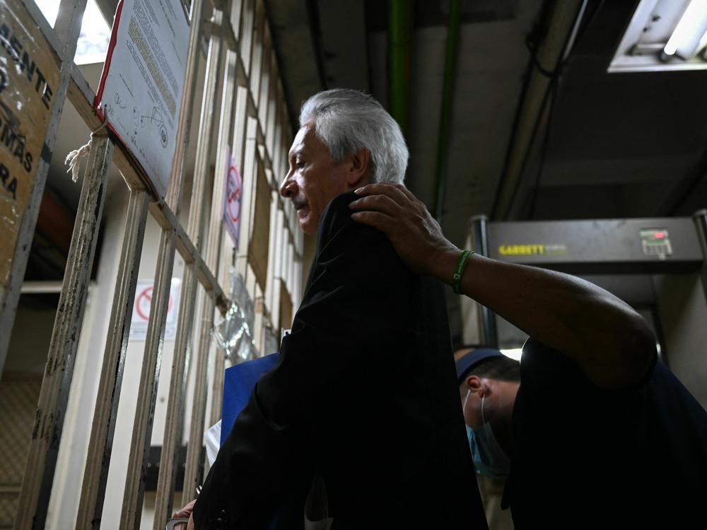 Guatemalan journalist José Rubén Zamora, president of the newspaper <em>El Periódico</em>, arrives handcuffed and under police escort to listen to a Guatemalan court's ruling in a case against him, at the Palace of Justice in Guatemala City, on Wednesday.