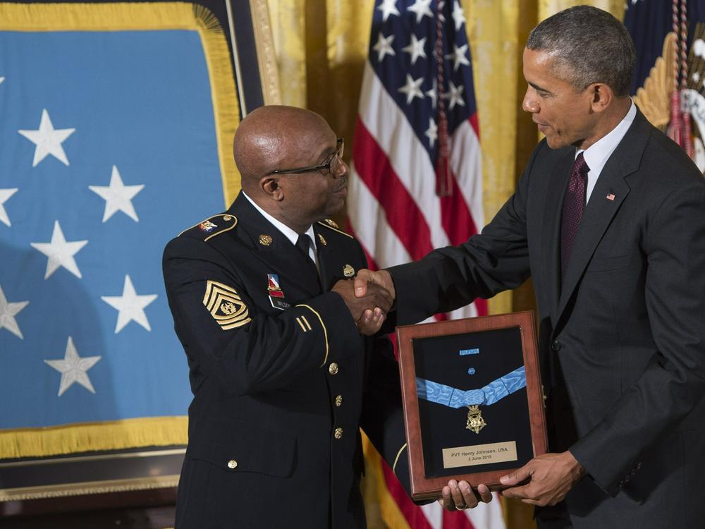 Then-President Barack Obama presents the Medal of Honor to Command Sergeant Major Louis Wilson of the New York National Guard, who accepted it on behalf of the late Army Private Henry Johnson, at the White House in June 2015.