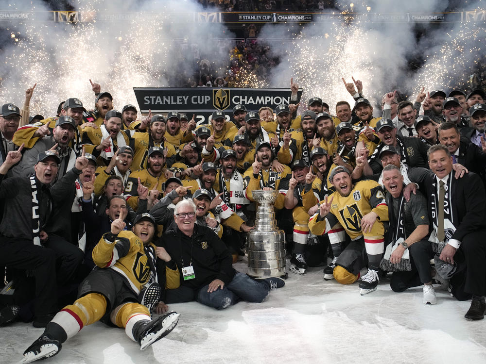Members of the Vegas Golden Knights pose with the Stanley Cup after the Knights defeated the Florida Panthers 9-3 in Game 5 of the NHL hockey Stanley Cup Finals Tuesday, June 13, 2023, in Las Vegas. The Knights won the series 4-1.