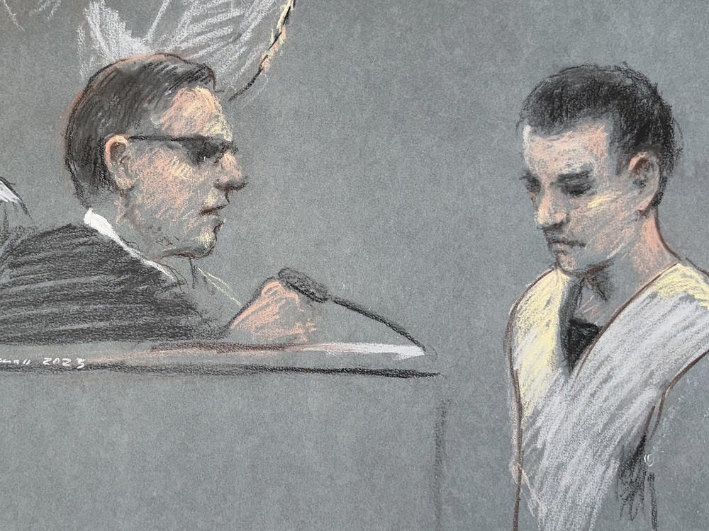 This artist depiction shows Massachusetts Air National Guardsman Jack Teixeira, right, appearing in U.S. District Court in Boston, April 14, 2023. Teixeira has been indicted on federal felony charges. The Justice Department says Teixeira faces six counts in the indictment of willful retention and transmission of national defense information.